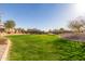 Well-maintained community green space, surrounded by trees and desert landscaping at 1060 W Castle Ct, Casa Grande, AZ 85122