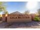 Gila Buttes community entrance sign with stone accents and manicured landscaping at 1060 W Castle Ct, Casa Grande, AZ 85122