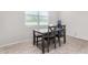 Cozy dining area with a table and four chairs, set near a window offering natural light and a view to the outdoors at 1060 W Castle Ct, Casa Grande, AZ 85122