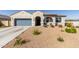 Charming single-story home with stucco exterior, desert landscaping, covered entryway, and attached two-car garage at 1060 W Castle Ct, Casa Grande, AZ 85122