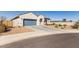 Inviting single-story home with a two-car garage, desert landscaping, and a concrete driveway in a quiet neighborhood at 1060 W Castle Ct, Casa Grande, AZ 85122