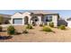 Lovely single-story home with desert landscaping, covered porch, and a two-car garage, offering curb appeal and comfort at 1060 W Castle Ct, Casa Grande, AZ 85122