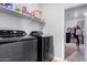 Laundry room featuring modern front load washer and dryer with closet at 1060 W Castle Ct, Casa Grande, AZ 85122