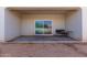 Covered patio area featuring a sliding glass door and a small outdoor table at 1060 W Castle Ct, Casa Grande, AZ 85122