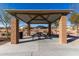 Community picnic area featuring a shaded structure, seating, and beautiful landscaping at 1060 W Castle Ct, Casa Grande, AZ 85122