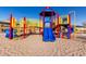 Colorful playground in the community with slides and climbing structures on a sand base at 1060 W Castle Ct, Casa Grande, AZ 85122