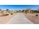 Scenic view of the community street featuring desert landscaping, mature trees and well-maintained grounds at 1060 W Castle Ct, Casa Grande, AZ 85122