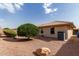 View of a desert landscaped backyard featuring mature trees, offering shade, and low maintenance upkeep at 10856 E Kiva Ave, Mesa, AZ 85209