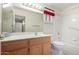 Bright bathroom featuring vanity and shower-tub combo with updated fixtures at 10856 E Kiva Ave, Mesa, AZ 85209