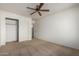 Comfortable bedroom with carpeted floor, ceiling fan and closet storage at 10856 E Kiva Ave, Mesa, AZ 85209