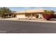 Welcoming home with a low-maintenance front yard featuring rock landscaping and colorful flowering bushes at 10856 E Kiva Ave, Mesa, AZ 85209