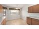 Kitchen eating area with wooden cabinets and large window at 10856 E Kiva Ave, Mesa, AZ 85209