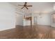 Spacious living room with lovely hardwood floors, a ceiling fan, and an open layout into the kitchen area at 10856 E Kiva Ave, Mesa, AZ 85209