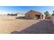 Large backyard with gravel, a block wall fence, and a covered patio at 11230 E Cliffrose Ln, Florence, AZ 85132