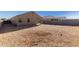 Gravel backyard featuring a covered patio, offering a great outdoor space for entertaining at 11230 E Cliffrose Ln, Florence, AZ 85132