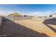 Gravel backyard featuring a block wall fence and clear blue sky at 11230 E Cliffrose Ln, Florence, AZ 85132