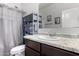 The bathroom features a large mirror, shelving, sink and shower with curtain rod at 11230 E Cliffrose Ln, Florence, AZ 85132