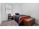 Simple bedroom with a blue bedspread, a wooden chest and a bedside table providing comfort at 11230 E Cliffrose Ln, Florence, AZ 85132