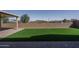 A backyard featuring a custom patio, lush artificial turf, and perimeter fencing at 11529 N 170Th Ln, Surprise, AZ 85388