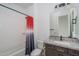 Bathroom featuring granite countertops, vanity with dark wood cabinets, and shower over tub at 11529 N 170Th Ln, Surprise, AZ 85388