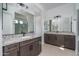 A bathroom featuring double sinks, granite counters, and modern fixtures at 11529 N 170Th Ln, Surprise, AZ 85388