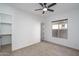 Bright and airy bedroom with neutral walls and carpet, ceiling fan, and a closet with shelving at 11529 N 170Th Ln, Surprise, AZ 85388