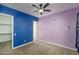 Stylish bedroom featuring custom-painted walls, ceiling fan, and a view of a large walk-in closet at 11529 N 170Th Ln, Surprise, AZ 85388