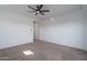 A well lit bedroom featuring carpeted floors, ceiling fan, and large windows at 11529 N 170Th Ln, Surprise, AZ 85388