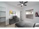 Stylish bedroom with unique décor, ceiling fan, neutral walls and carpet, and bright natural light at 11529 N 170Th Ln, Surprise, AZ 85388