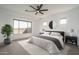 Stylishly staged main bedroom featuring plush carpets, fan and modern decor at 11529 N 170Th Ln, Surprise, AZ 85388