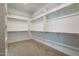 A large walk-in closet with multiple shelves and storage at 11529 N 170Th Ln, Surprise, AZ 85388