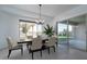 Bright and airy dining room with modern chandelier and sliding glass door to the backyard at 11529 N 170Th Ln, Surprise, AZ 85388