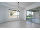 This dining room has tile floors, light walls, and a view to the back yard through a window at 11529 N 170Th Ln, Surprise, AZ 85388