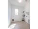 Well-lit laundry room featuring tile flooring, a window, and washer and dryer hookups at 11529 N 170Th Ln, Surprise, AZ 85388