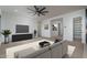 Another view of the living room with modern furniture, TV, and an open floor plan at 11529 N 170Th Ln, Surprise, AZ 85388