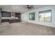 Open-concept living area featuring a modern kitchen and abundant natural light from large windows at 11529 N 170Th Ln, Surprise, AZ 85388