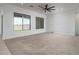 Spacious living area with neutral carpet, bright white walls, and large windows offering plenty of light at 11529 N 170Th Ln, Surprise, AZ 85388