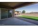 Covered patio area with seamless transition to an outdoor living space, including an artificial turf lawn at 11529 N 170Th Ln, Surprise, AZ 85388