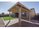 Angle view of a backyard pergola highlighting seamless connection to home with artificial turf and block wall at 11529 N 170Th Ln, Surprise, AZ 85388