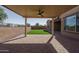 View from under the pergola overlooking the backyard with artificial turf and block wall at 11529 N 170Th Ln, Surprise, AZ 85388