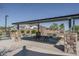 Community picnic area with stone-clad columns, tables, and shade structure at 11529 N 170Th Ln, Surprise, AZ 85388