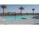 Community swimming pool surrounded by lounge chairs and palm trees at 11529 N 170Th Ln, Surprise, AZ 85388