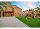 Exterior backyard view with play-set, lawn, and covered porch at 12118 W Villa Chula Ct, Sun City, AZ 85373