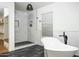 Bright bathroom featuring a soaking tub, step-in shower, window, and decorative lighting at 12118 W Villa Chula Ct, Sun City, AZ 85373