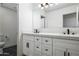 Bright bathroom featuring double sinks, white cabinets, and contemporary design at 12118 W Villa Chula Ct, Sun City, AZ 85373