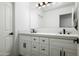 Elegant bathroom with double vanity, white cabinetry, and modern fixtures at 12118 W Villa Chula Ct, Sun City, AZ 85373