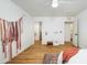 Spacious bedroom featuring wood-look floors and neutral wall color. Features a view into the other rooms at 12118 W Villa Chula Ct, Sun City, AZ 85373