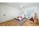 Bright bedroom with ceiling fan, wood-look floors, rug, and a playful teepee featuring a giraffe at 12118 W Villa Chula Ct, Sun City, AZ 85373