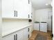 Organized laundry room with ample storage cabinets, modern washer, and dryer units at 12118 W Villa Chula Ct, Sun City, AZ 85373