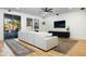 Cozy living room with large white couch, modern ceiling fan, and sliding door to the outside at 12118 W Villa Chula Ct, Sun City, AZ 85373